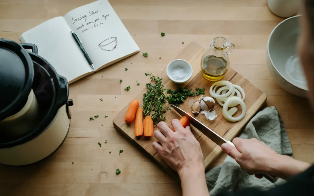 Home cook preparing ingredients beside a slow cooker